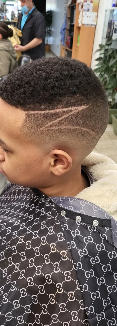 Curly haircut with shaved side design